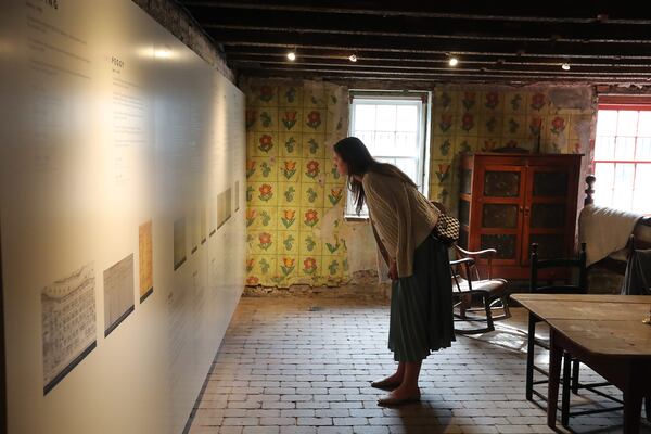 A visitor reads the names of the 13 enslaved individuals that were owned by the Davenport Family at the new Urban Enslaved exhibit at the Davenport House Museum.