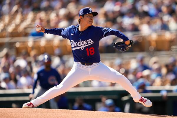 Los Angeles Dodgers pitcher Yoshinobu Yamamoto throws during the first inning of a spring training baseball game against the Chicago Cubs, Thursday, Feb. 20, 2025, in Phoenix. (AP Photo/Ashley Landis)