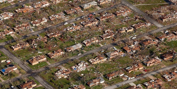 FILE- This aerial photograph shows a neighborhood destroyed by a powerful tornado in Joplin, Mo. Tuesday, May 24, 2011. (AP Photo/Charlie Riedel, File)