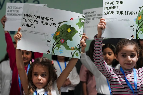 Children advocate for a clean planet during the COP29 U.N. Climate Summit, Thursday, Nov. 21, 2024, in Baku, Azerbaijan. (AP Photo/Peter Dejong)