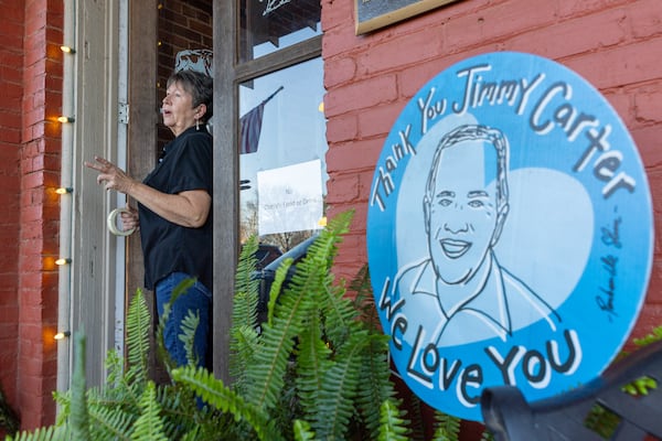 Mary Mancus, manager of Plains' Buffalo Cafe, speaks to a reporter outside the restaurant.