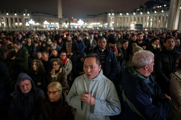 Faithful pray during a nightly rosary in St. Peter's Square at The Vatican for Pope Francis' recovery, Monday, Feb. 24, 2025. (AP Photo/Bernat Armangue)