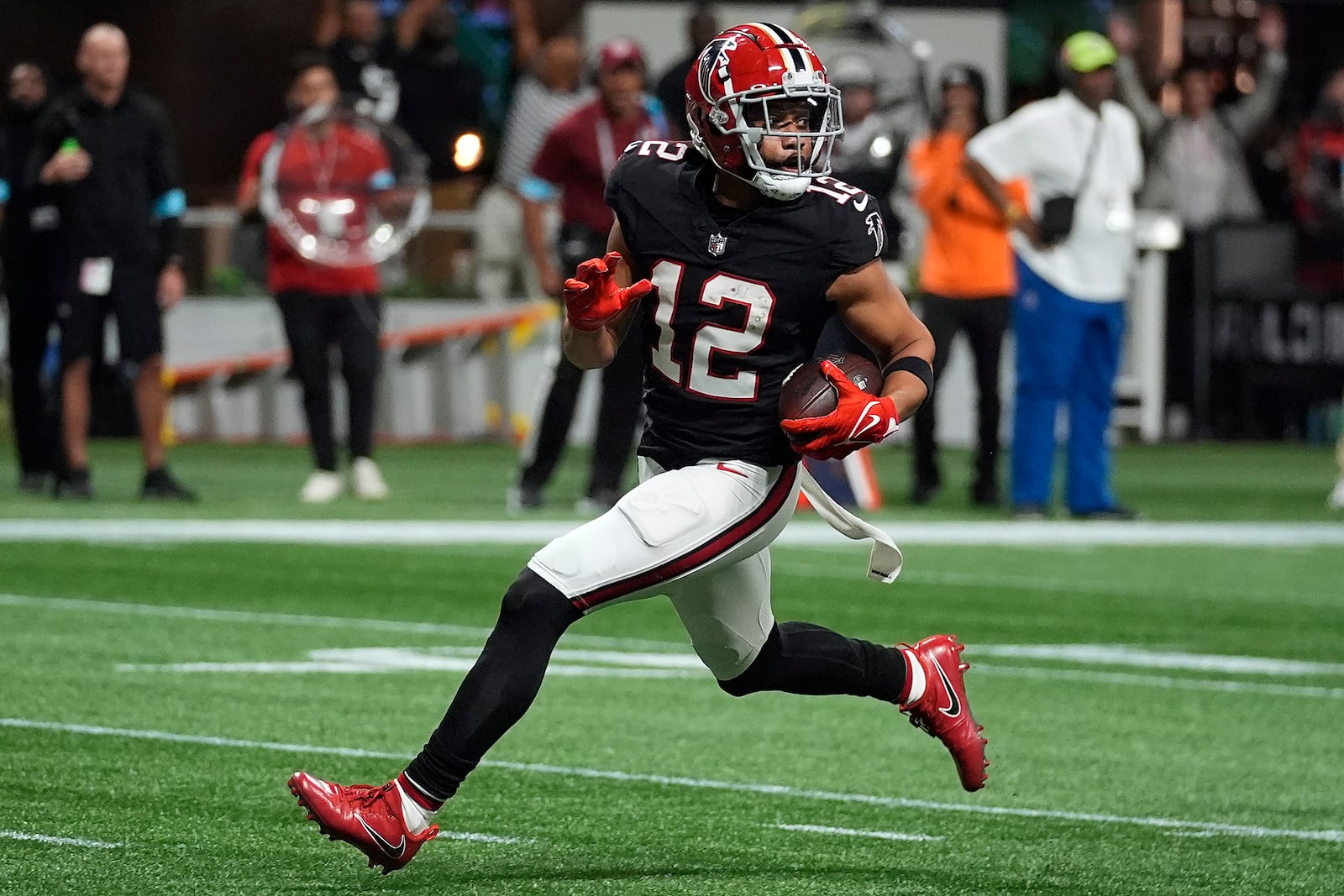 Atlanta Falcons wide receiver KhaDarel Hodge (12) scores the game-wining touchdown against the Tampa Bay Buccaneers during overtime in an NFL football game Thursday, Oct. 3, 2024, in Atlanta. (AP Photo/John Bazemore)