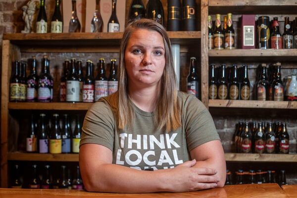 Former New Realm Brewing employee Tracy Bardugon sits for a portrait at The Porter Beer Bar in Atlanta’s Little Five Points community, Monday, June 14, 2021. (Alyssa Pointer / Alyssa.Pointer@ajc.com)