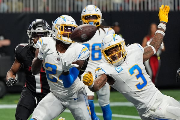 Los Angeles Chargers safety Marcus Maye (24) intercepts the ball thrown by Atlanta Falcons quarterback Kirk Cousins (18) during the second half of an NFL football game on Sunday, Dec. 1, 2024 in Atlanta. (AP Photo/Mike Stewart)