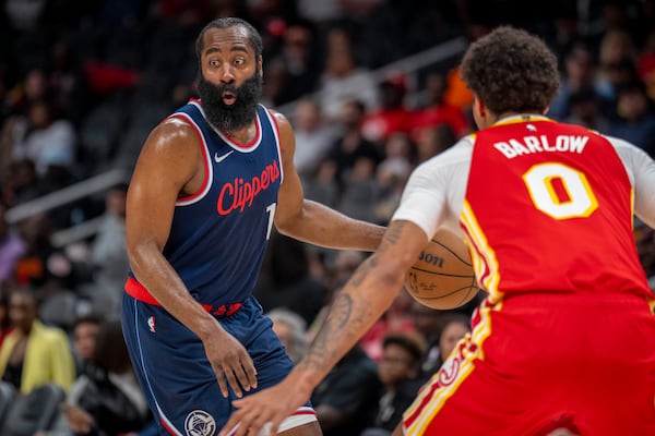 Los Angeles Clippers guard James Harden (1), left, attempts to pass the ball against Atlanta Hawks forward Dominick Barlow (0), right, during the first half of an NBA basketball game, Friday, March 14, 2025, in Atlanta. (AP Photo/Erik Rank)