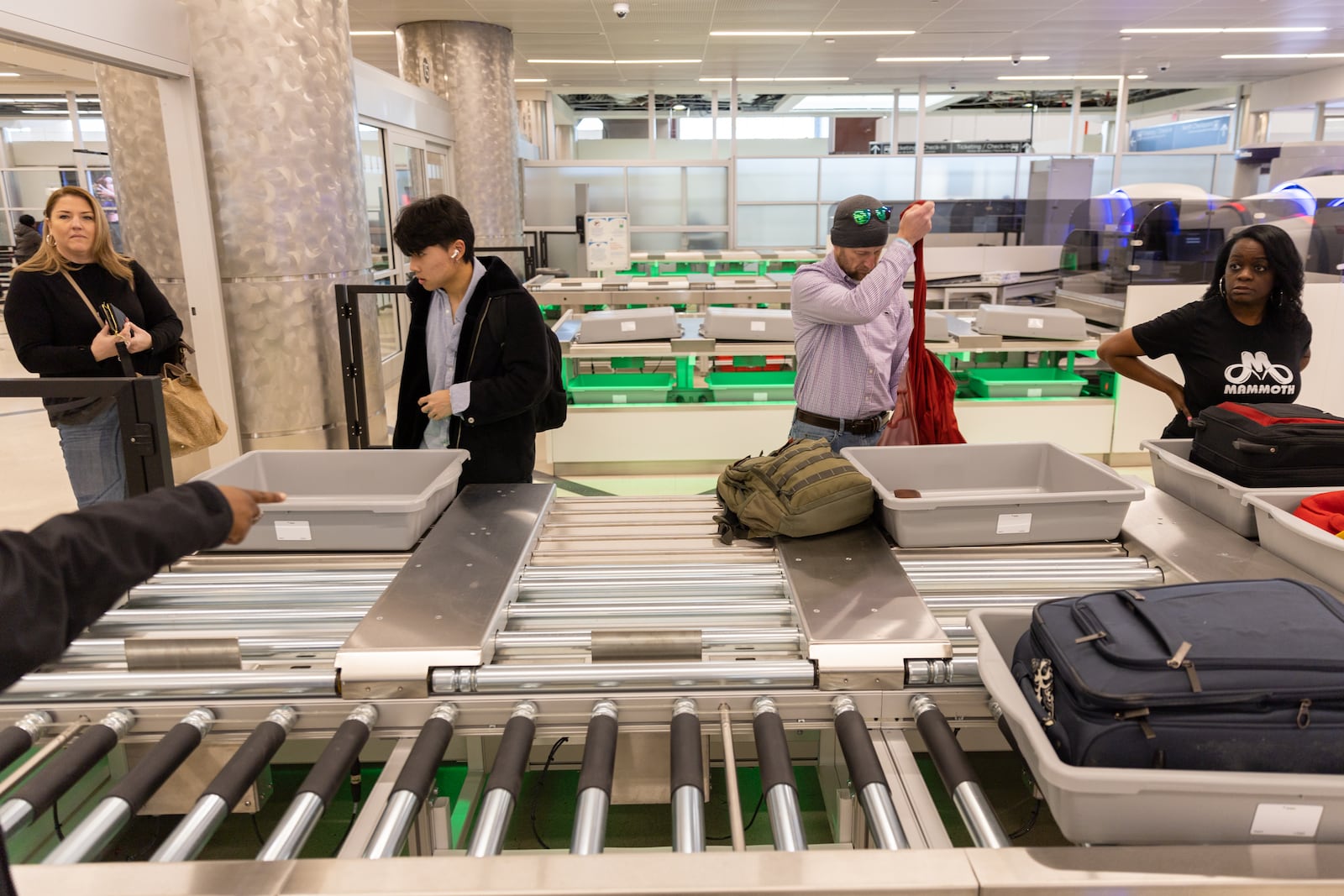 Travelers pass through a newly reopened lane during a security screening in the domestic terminal at Hartsfield-Jackson in Atlanta on Thursday, December 14, 2023. (Arvin Temkar / arvin.temkar@ajc.com)