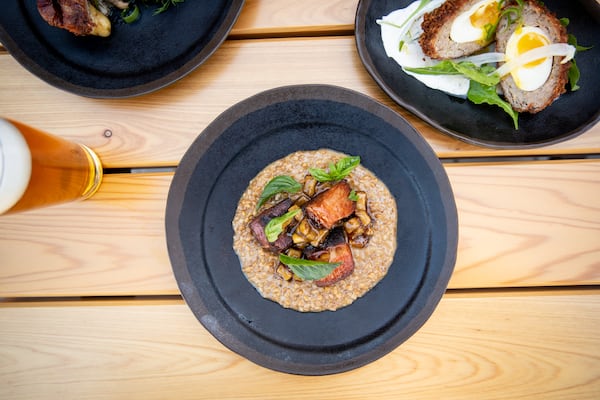 Biggerstaff Crispy Pork Belly with creamed farro and seasonal fruit. (Mia Yakel for The Atlanta Journal-Constitution)