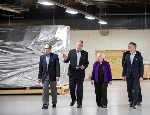 Secretary of the Treasury Janet Yellen is in Norcorss at Suniva, a solar cell manufacturing facility, where she tours the facility with Suniva executives, including President and COO Matt Card, second from left, on Wednesday, March 27, 2024 touting the Inflation Reduction Act and touring the facility that is reopening thanks to those tax credits and a favorable solar market. (Jenni Girtman for The Atlanta Journal-Constitution)