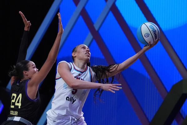 Vinyl forward Dearica Hamby goes up for the game-winning basket past Lunar Owls forward Napheesa Collier in their Unrivaled 3-on-3 basketball semifinal, Sunday, March 16, 2025, in Medley, Fla. (AP Photo/Rebecca Blackwell)