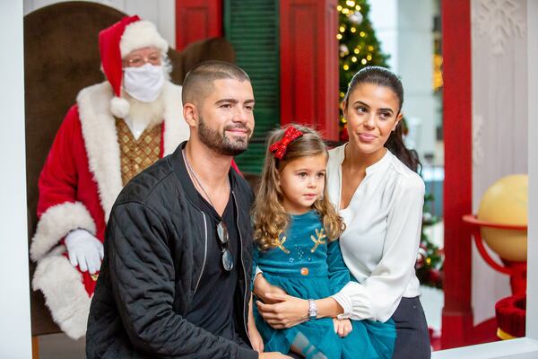    
David Greenwald, Alex Ellul, and her daughter Logan Rush, 3, pose for a photograph with Santa Clause at the  Perimeter Mall Sunday, November 22, 2020. STEVE SCHAEFER / SPECIAL TO THE AJC 