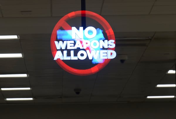 A holographic image advising passengers against bringing weapons into the security checkpoint area is seen Wednesday, April 6, 2022 at Hartsfield-Jackson International Airport. (Daniel Varnado/For the Atlanta Journal-Constitution)