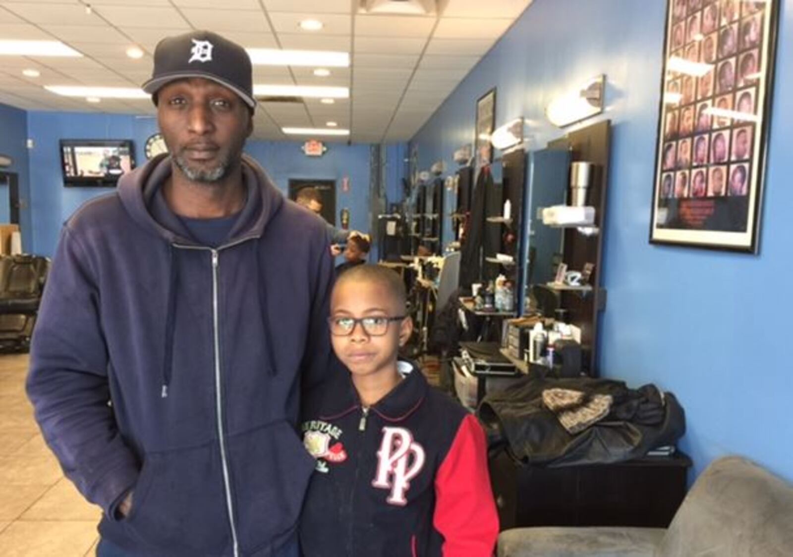 Andre Hudson and his son 9-year-old son Dametrice Tims waited to get haircuts Saturday at Southside Kutz Barbershop in southwest Atlanta. LAUREN FOREMAN / LAUREN.FOREMAN@AJC.COM