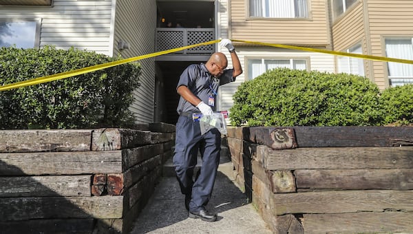 August 7, 2018 Gwinnett County: A Gwinnett County police crime scene specialist exits under the tape after collecting evidence. A woman was shot and killed in a domestic dispute at an apartment near Duluth Tuesday morning August 7, 2018, police said. The woman was found shot and taken to an area hospital, where she later died of her injuries. JOHN SPINK/JSPINK@AJC.COM