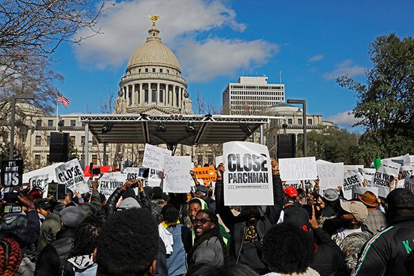 Several hundred people gather Jan. 24 in front of the Mississippi Capitol in Jackson to protest conditions in prisons where inmates have been killed in violent clashes in recent weeks. Mississippi's new governor Tate Reeves says he and the interim corrections commissioner toured a troubled state prison to see conditions and to try to understand what led to an outburst of deadly violence in recent weeks.