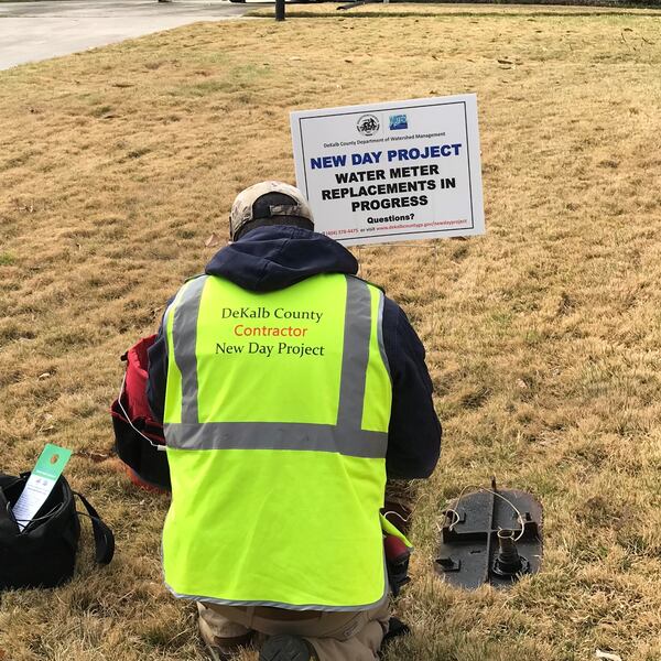 A contractor installs a new water meter in DeKalb County. CONTRIBUTED