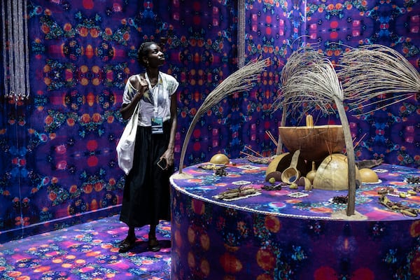 A visitor explores the international exhibit at the Dakar Biennale of Contemporary African Art in Dakar, Senegal, Friday, Nov. 8, 2024. (AP Photo/Annika Hammerschlag)