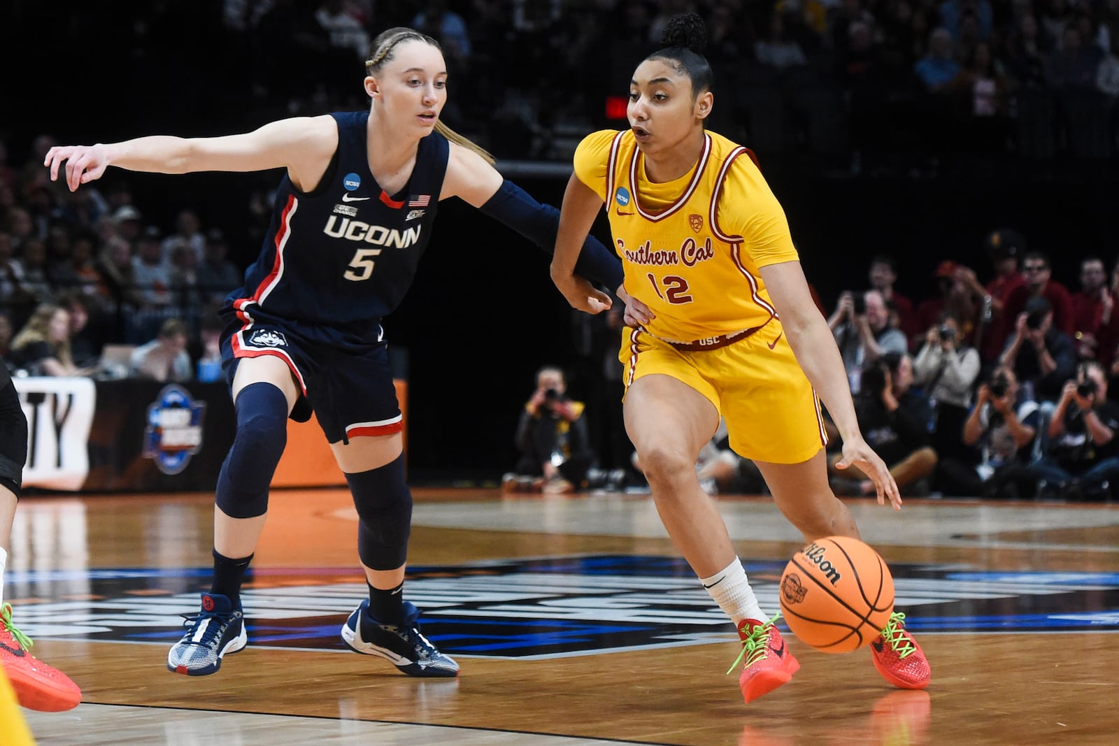 FILE -Southern California guard JuJu Watkins (12) drives to the basket past UConn guard Paige Bueckers (5) during the first half of an Elite Eight college basketball game in the women's NCAA Tournament, Monday, April 1, 2024, in Portland, Ore. (AP Photo/Steve Dykes, File)