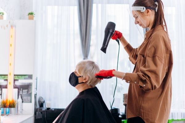 A stylist works on a DashStylists client’s hair. DashStylists is a platform that connects a primarily senior customer base with mobile stylists.