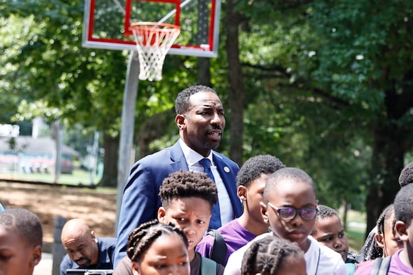 Atlanta Mayor Andre Dickens takes a photo with students in the Camp Best Friends Summer Program following a ribbon cutting ceremony for the new basketball court at Pittman Park on Wednesday, July 13, 2022. The court  will be a part of his Midnight Basketball initiative created to give youth a place to spend time. (Natrice Miller/natrice.miller@ajc.com)