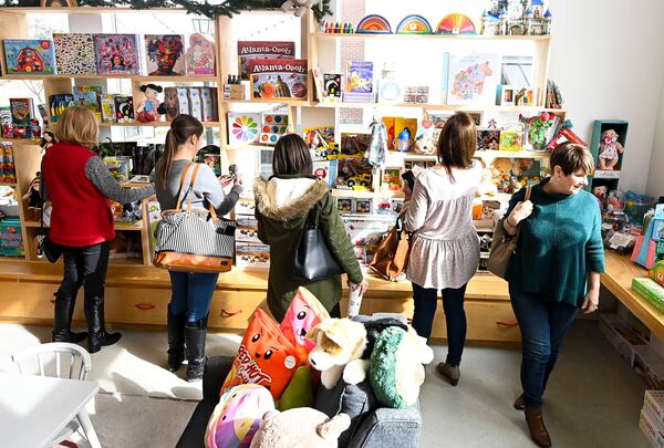 Patrons browse through the selection of children's toys at Hello Rainbow toy store in Duluth on Tuesday, Dec. 7, 2021. (Daniel Varnado/ For the Atlanta Journal-Constitution)