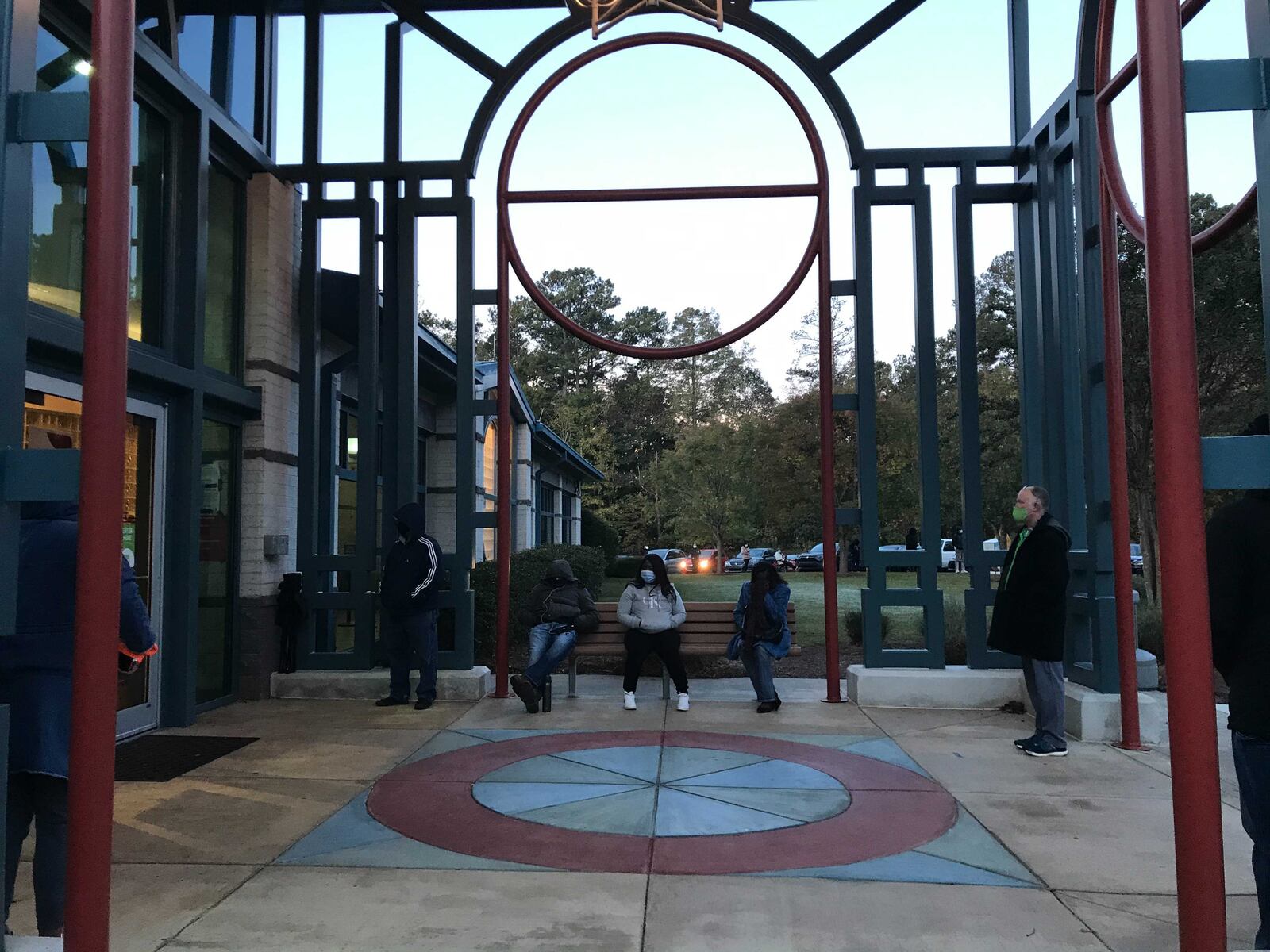 The first voters at Lucky Shoals Community Center in Gwinnett wait for the doors to open. Some have brought chairs and hot beverages. VANESSA MCCRAY