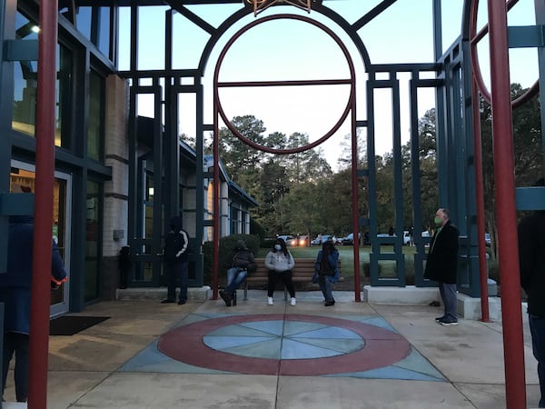 The first voters at Lucky Shoals Community Center in Gwinnett wait for the doors to open. Some have brought chairs and hot beverages. VANESSA MCCRAY