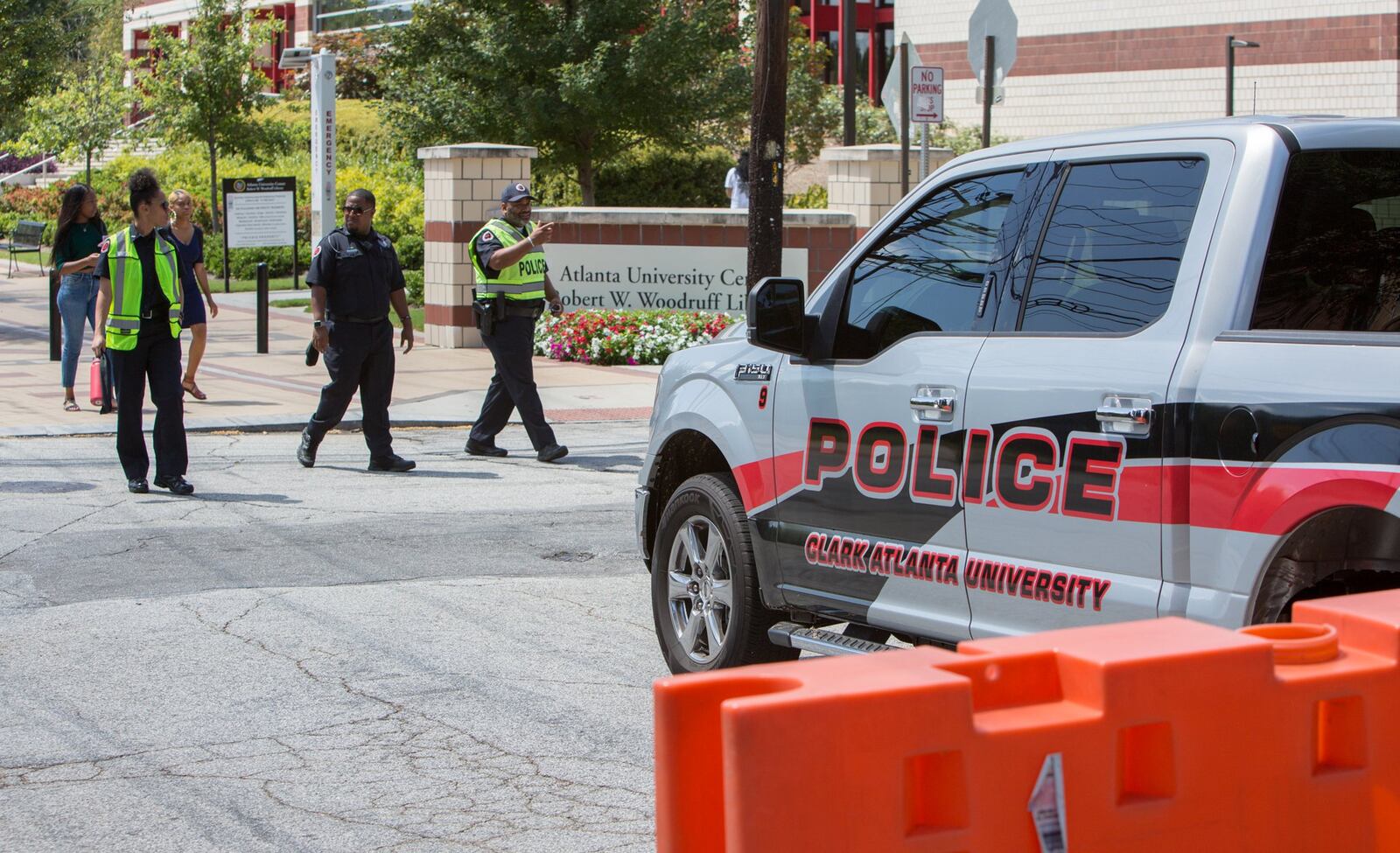 Three Clark Atlanta University police walk through the campus near where shooting reportedly broke out during a party on the steps of the Atlanta University Center early Wednesday morning injuring several students on the first day of classes in Atlanta, GA on August 21st, 2019. (Photo by Phil Skinner / For The Atlanta Journal-Constitution).