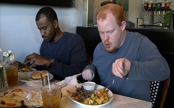 Food blogger Alex Jenkins and his caregiver, Spencer Moore, eat lunch at Kebab Grill in Charlotte, N.C. (Justine Miller/Charlotte Observer/TNS)