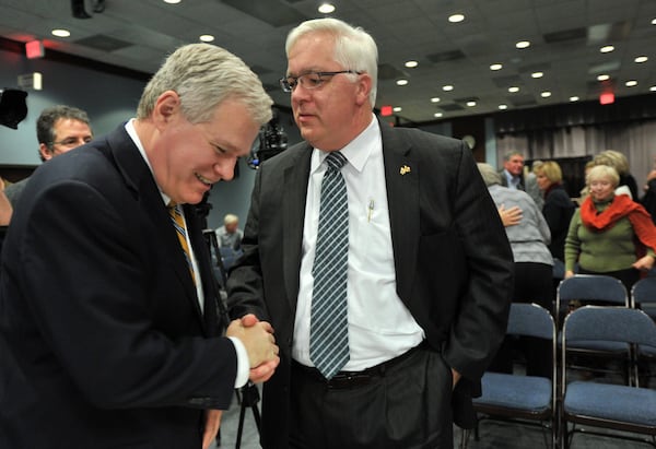 Tim Lee (right) shakes hands with his lawyer Ben Mathis after an ethics complaint case against Lee was dismissed during a hearing in November 2014. Cobb County resident Tom Cheek filed the complaint against Lee, who was County Commission chairman at the time. 