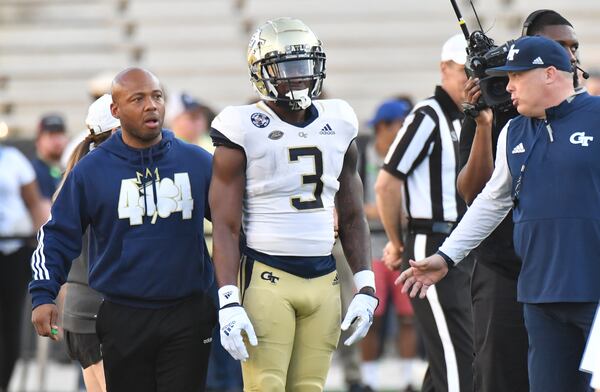 Georgia Tech's running backs coach Mike Daniels and head coach Geoff Collins talk to running back Hassan Hall during the 2022 Spring Game at Georgia Tech's Bobby Dodd Stadium in Atlanta on Thursday, March 17, 2022. (Hyosub Shin / Hyosub.Shin@ajc.com)