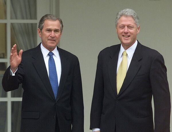 FILE - President Bill Clinton, right, and President-elect George W. Bush pose for photographers as they head to the Oval Office at the White House Dec. 19, 2000. (AP Photo/Ron Edmonds, File)