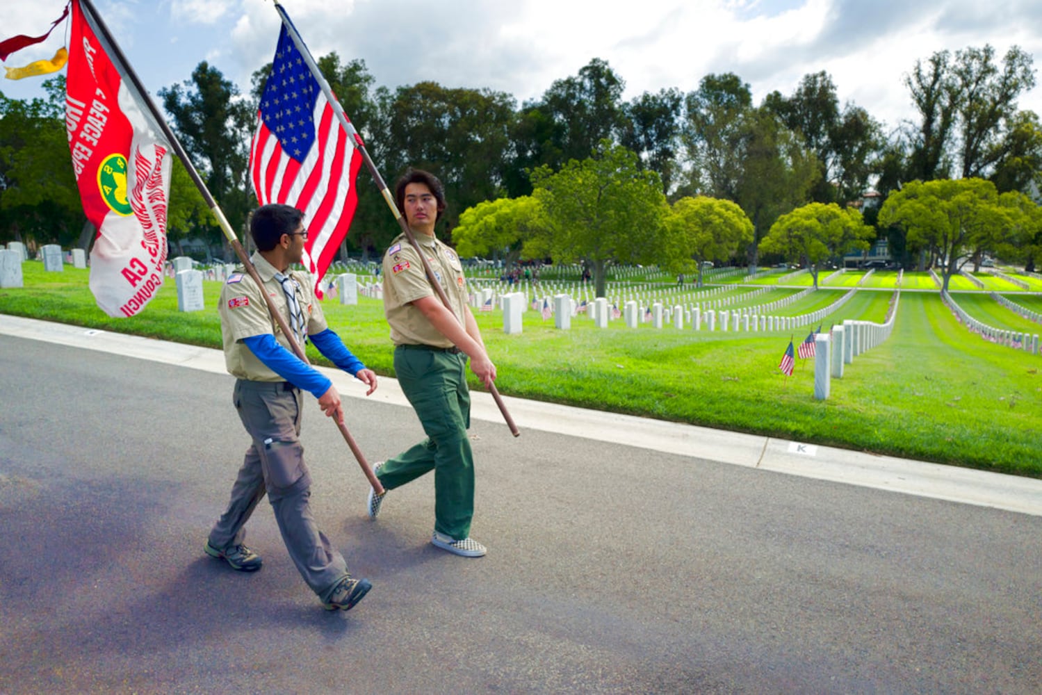 scouts place flags at veteran graves to honor memorial day