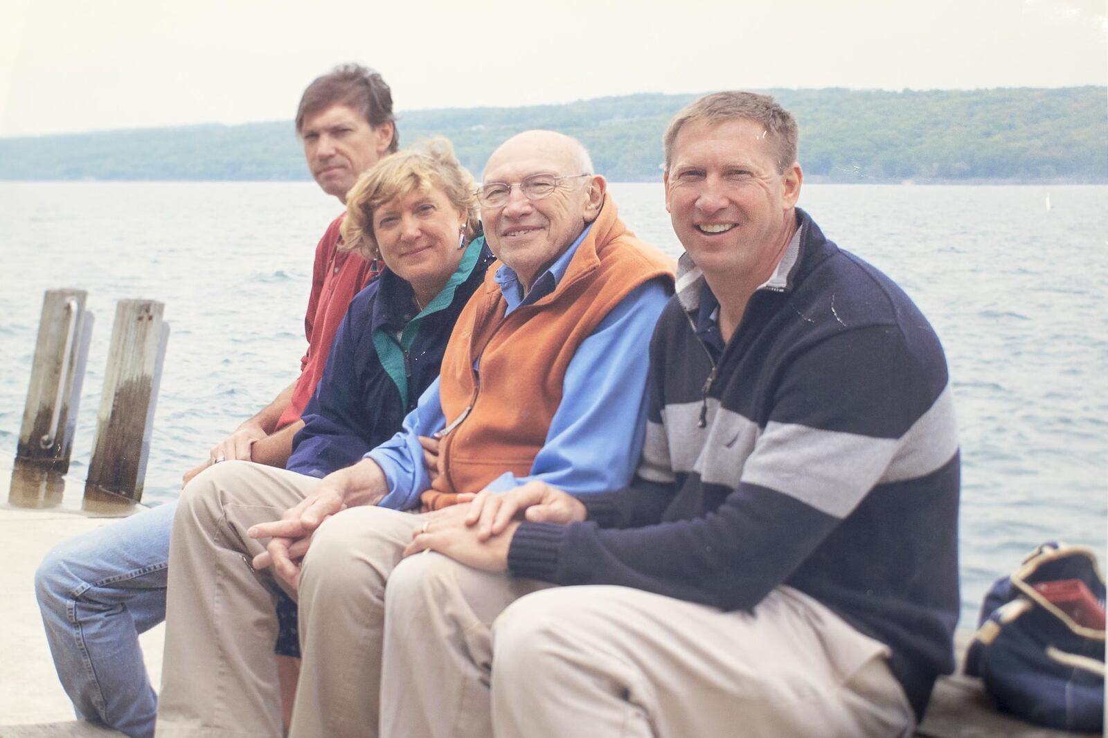 Adam Bennett, center, relaxes with his children Douglas Bennett, left, Christine Houk and Bruce Bennett at the lake where they scattered the remains of Adam's wife, Nancy, after her 2008 death. Adam Bennett died in 2017 of injuries suffered at Sunrise at East Cobb. (Family photo)