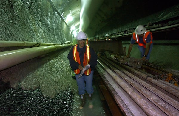 Mayor Shirley Franklin walks past a train car while touring Nancy Creek tunnel to mark the one-year anniversary of Clean Water Atlanta. The tunnel, just over 18 feet in diameter and currently 1 mile long, will carry sanitary waste. (AJC File)