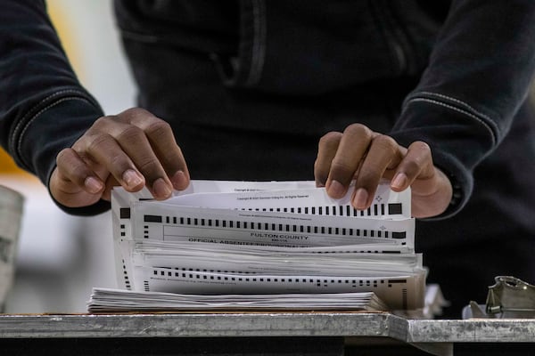 A Fulton County elections workers prepares absentee ballots for counting during the county's second recount of Presidential Election Day ballots at the Georgia World Congress Center, Tuesday, Nov. 25, 2020. (Alyssa Pointer/Alyssa.Pointer@ajc.com)