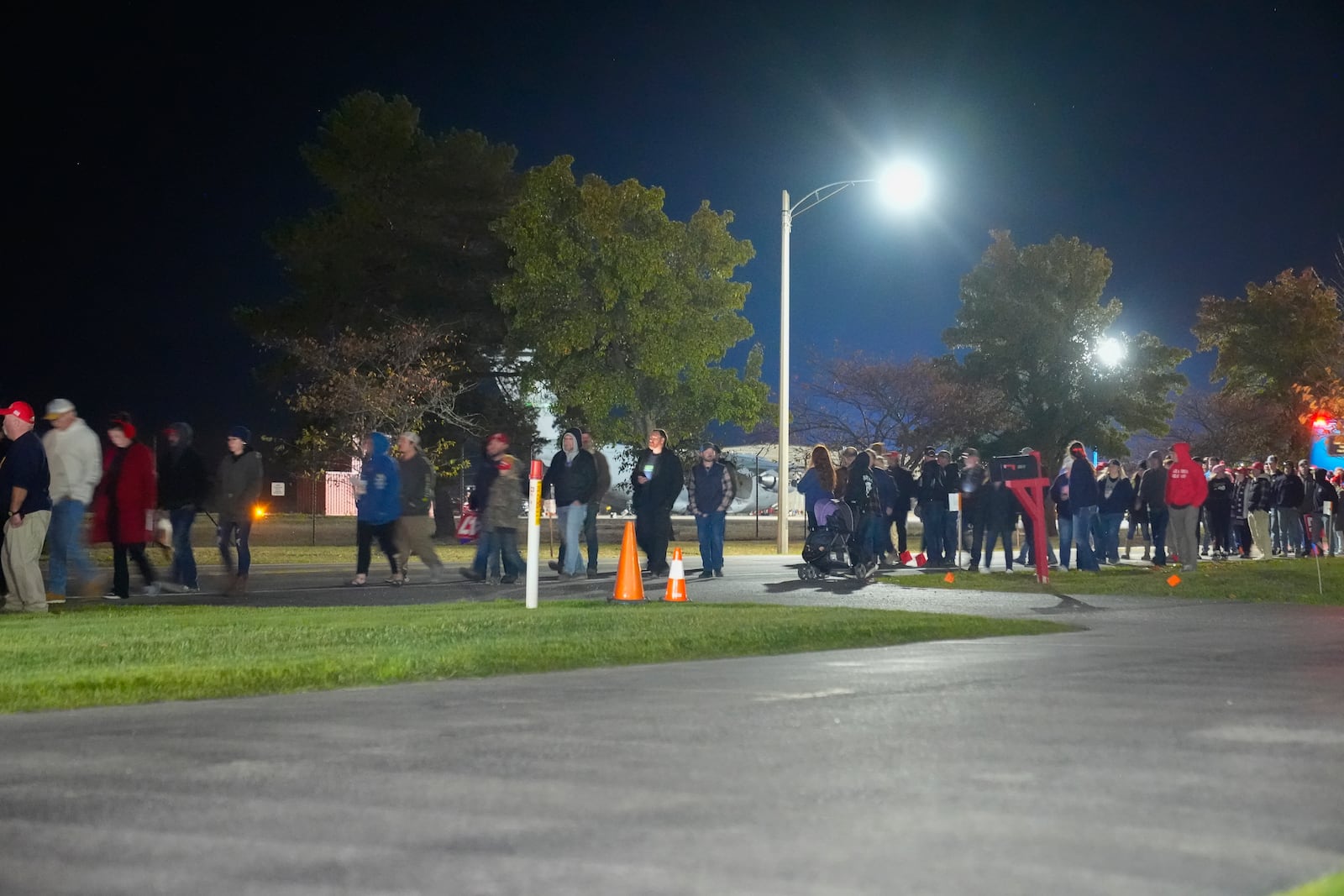 Supporters are seen leaving a campaign rally ahead of the arrival of Republican presidential nominee former President Donald Trump at Cherry Capital Airport, Friday, Oct. 25, 2024, in Traverse City, Mich. (AP Photo/Alex Brandon)