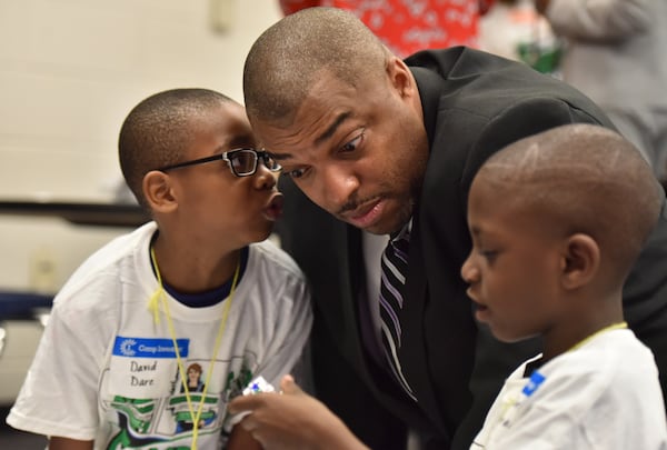 Clayton County Schools Superintendent Morcease Beasley with two students.