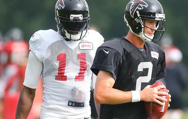 081815 FLOWERY BRANCH: Falcons quarterback Matt Ryan and wide receiver Julio Jones prepare to run a play during team practice on Tuesday, August, 18, 2015, in Flowery Branch. Curtis Compton / ccompton@ajc.com