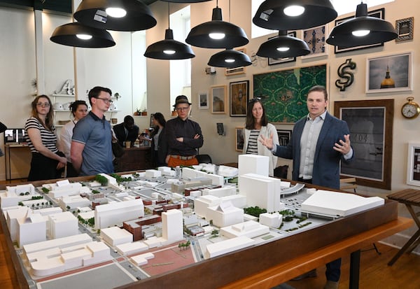 Jon Birdsong (right) and April Stammel (second from right) speak to attendees before walking tour of South Downtown, Tuesday, Mar. 12, 2024, in Atlanta. (Hyosub Shin / Hyosub.Shin@ajc.com)