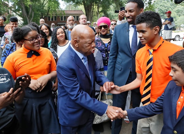 U.S. Rep. John Lewis greets seventh graders Arin Hilson, Brandon Daniels and Juan Pacheco from the John Lewis Invictus Academy as he arrived for the dedication ceremony.