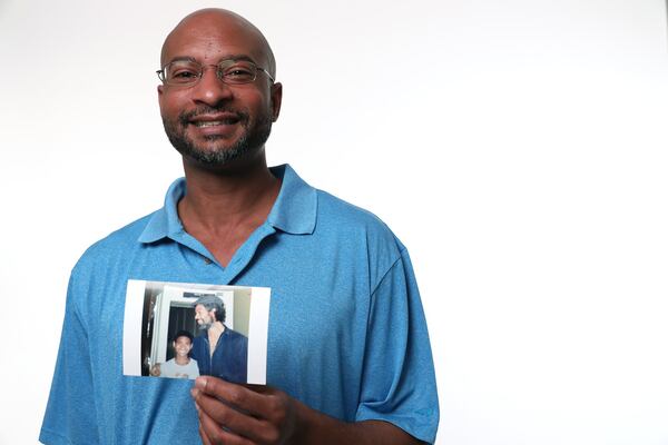 Rumal Rackley holds a picture of him with his legendary father Gil Scott-Heron. RYON HORNE / RHORNE@AJC.COM