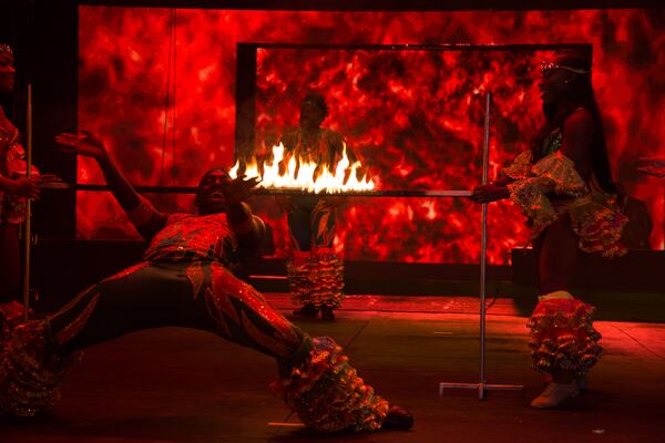 Members of the Caribbean Dynasty Dancers Limbo under a burning bar during their UniverSoul Circus performance Sunday, February 11, 2018, in Atlanta.  STEVE SCHAEFER / SPECIAL TO THE AJC