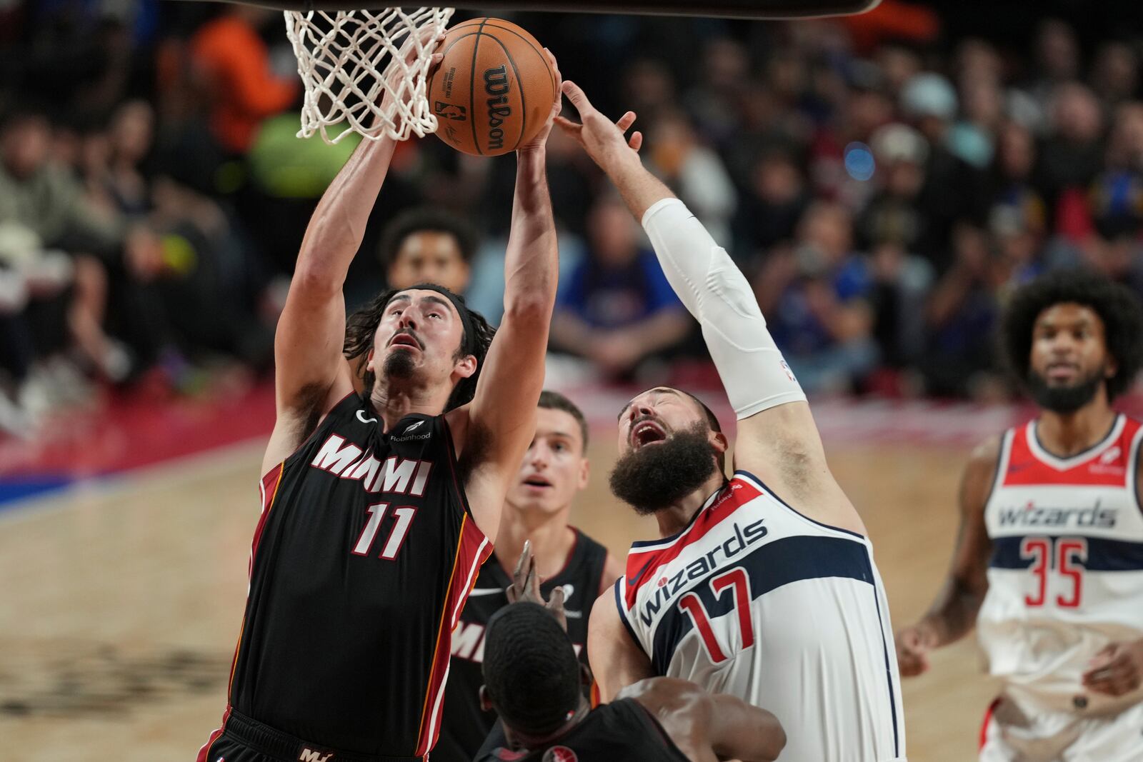 Miami Heat Jaime Jaquez Jr., left, and Washington Wizards Jonas Valančiūnas fight for a rebound during the first half of an NBA basketball game, at the Mexico Arena in Mexico City, Saturday, Nov. 2, 2024. (AP Photo/Fernando Llano)