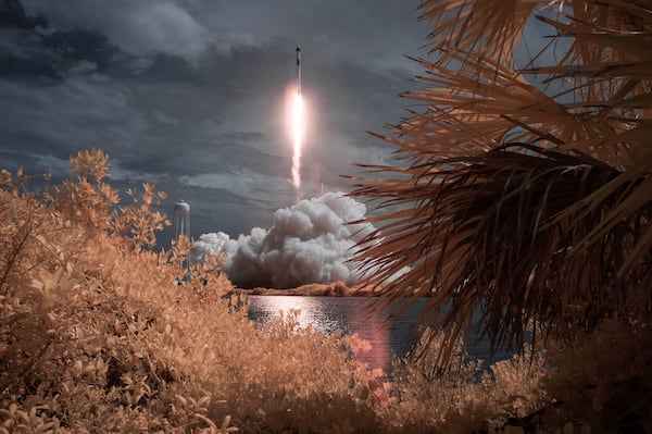 In this photo provided by NASA, a SpaceX Falcon 9 rocket carrying the company's Crew Dragon spacecraft is seen in this false-color infrared exposure as it is launched on NASA's SpaceX Demo-2 mission to the International Space Station.