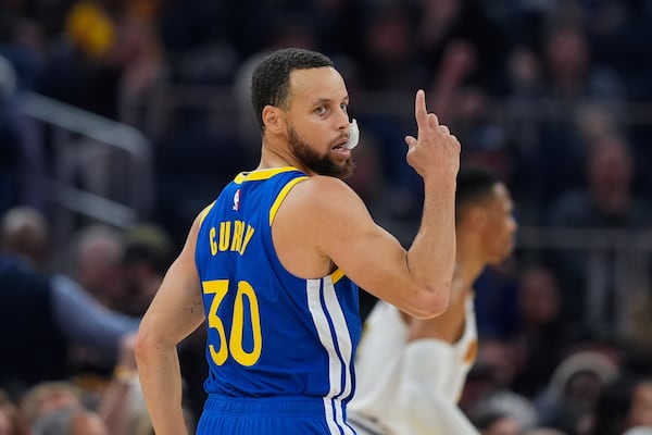 Golden State Warriors guard Stephen Curry reacts after making a 3-point basket during the first half of an NBA basketball game against the Denver Nuggets, Monday, March 17, 2025, in San Francisco. (AP Photo/Godofredo A. Vásquez)