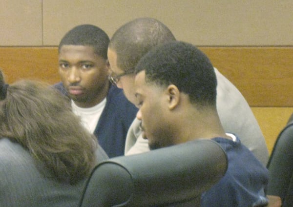 Otis Ricks, left, and co-defendant DeMario Carman flank attorney Overton Thierry during a hearing in Fulton County Superior Court.