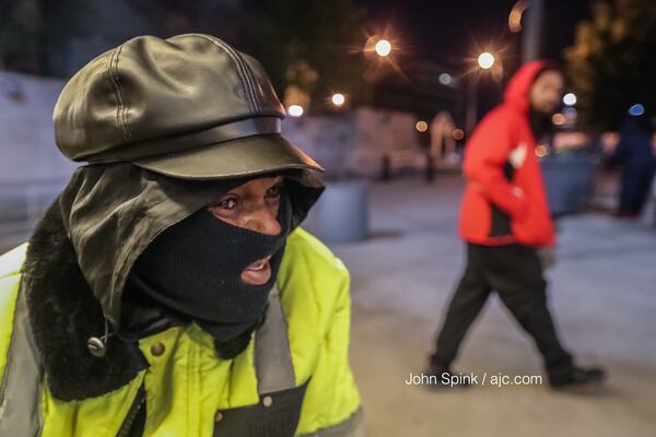 Gene Tillman is bundled up in full winter gear as he sits at Five Points in downtown Atlanta on Friday morning. JOHN SPINK / JSPINK@AJC.COM