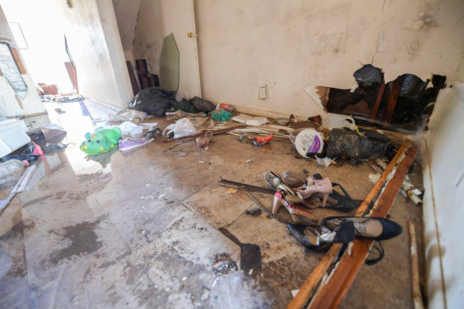 A broken pipe spews water (right side of picture) into the kitchen of an abandoned apartment at the Forest Cover apartment complex Tuesday, Feb. 1, 2022. (Daniel Varnado/For the Atlanta Journal-Constitution)