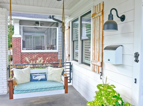 Homeowner Grace White actually found the swing she bought for her front porch on Facebook. She tied it up with rope and found a crib mattress to fit the frame. With a couple of plush pillows and a whale throw pillow to carry the coastal theme, she made a lovely porch space. Text by Lori Johnston and Shannon Adams/Fast Copy News Service. (Christopher Oquendo Photography/www.ophotography.com)